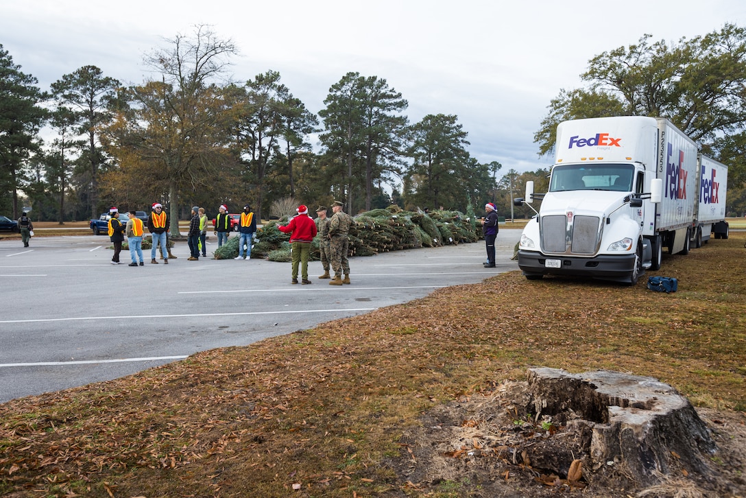 Leaders from Marine Corps Base (MCB) Camp Lejeune, Marine Corps Community Services Lejeune-New River, and volunteers prepare for the Trees for Troops event on MCB Camp Lejeune, Dec. 1, 2023.  Trees for Troops is an annual event held by the Christmas SPIRIT Foundation providing approximately 1,000 Christmas trees to Department of Defense personnel on MCB Camp Lejeune and Marine Corps Air Station New River with a mission to spread Christmas spirit throughout every military family. (U.S. Marine Corps photo by Lance Cpl. Loriann Dauscher)
