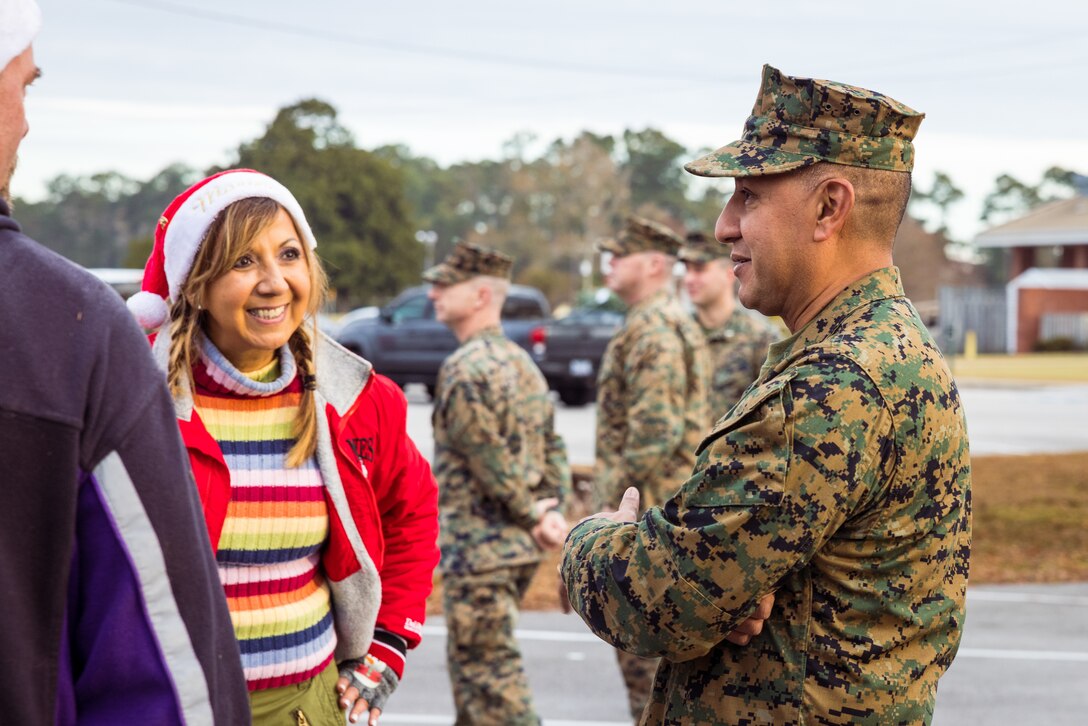 U.S. Marine Corps Col. Adolfo Garcia Jr., right, commander, Marine Corps Installations East-Marine Corps Base (MCB) Camp Lejeune, speaks to Yolanda Mayo, deputy operations officer for Marine Corps Community Services Lejeune-New River during the Trees for Troops event on MCB Camp Lejeune, North Carolina, Dec. 1, 2023. Trees for Troops is an annual event held by the Christmas SPIRIT Foundation providing approximately 1,000 Christmas trees to Department of Defense personnel on MCB Camp Lejeune and Marine Corps Air Station New River with a mission to spread Christmas spirit throughout every military family. (U.S. Marine Corps photo by Lance Cpl. Loriann Dauscher)