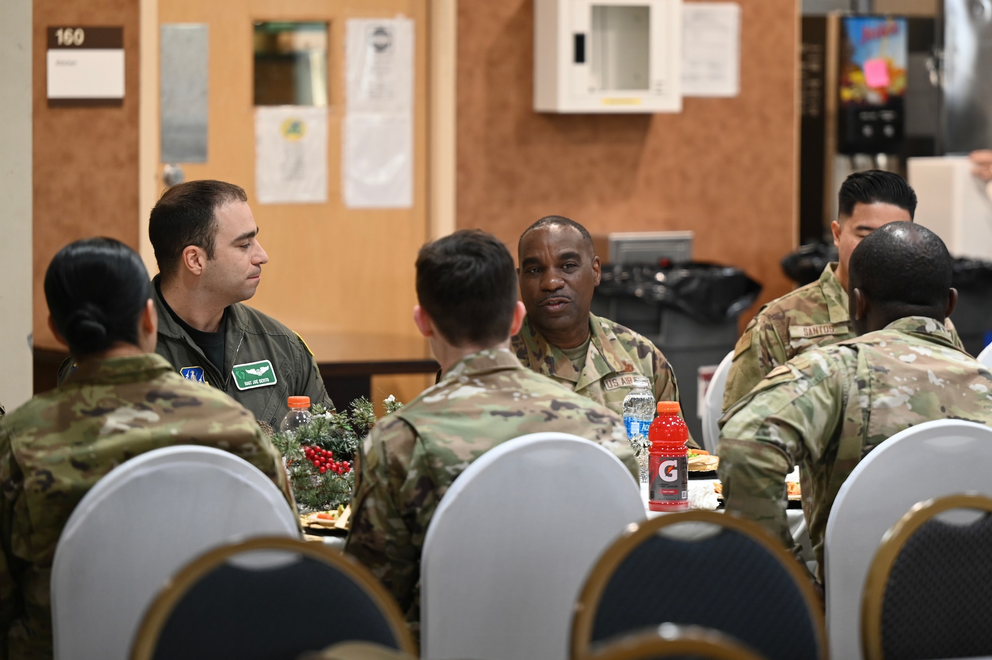 U.S. Air Force Chief Master Sgt. Maurice L. Williams, center, command chief, Air National Guard (ANG), attends lunch with 10 Airmen from the 106th Rescue Wing, New York National Guard, at Francis S. Gabreski ANG Base in Westhampton Beach, New York, Dec. 1, 2023. The 10 Airmen were given the opportunity to sit down with Williams for a one-on-one conversation. (U.S. Air National Guard photo by Airman 1st Class Sarah McKernan)