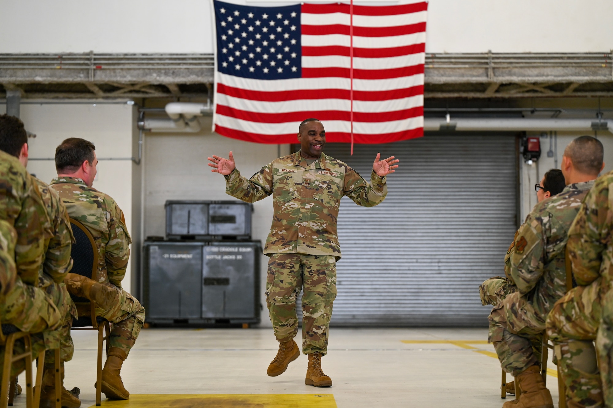 U.S. Air Force Chief Master Sgt. Maurice L. Williams, center, command chief, Air National Guard (ANG), speaks at a town hall meeting with enlisted members of the 106th Rescue Wing, New York National Guard, at Francis S. Gabreski ANG Base in Westhampton Beach, NY, December 1, 2023. During his visit, Williams discussed the National Defense Strategy and upcoming changes for the ANG. (U.S. Air National Guard photo by Airman 1st Class Sarah McKernan)