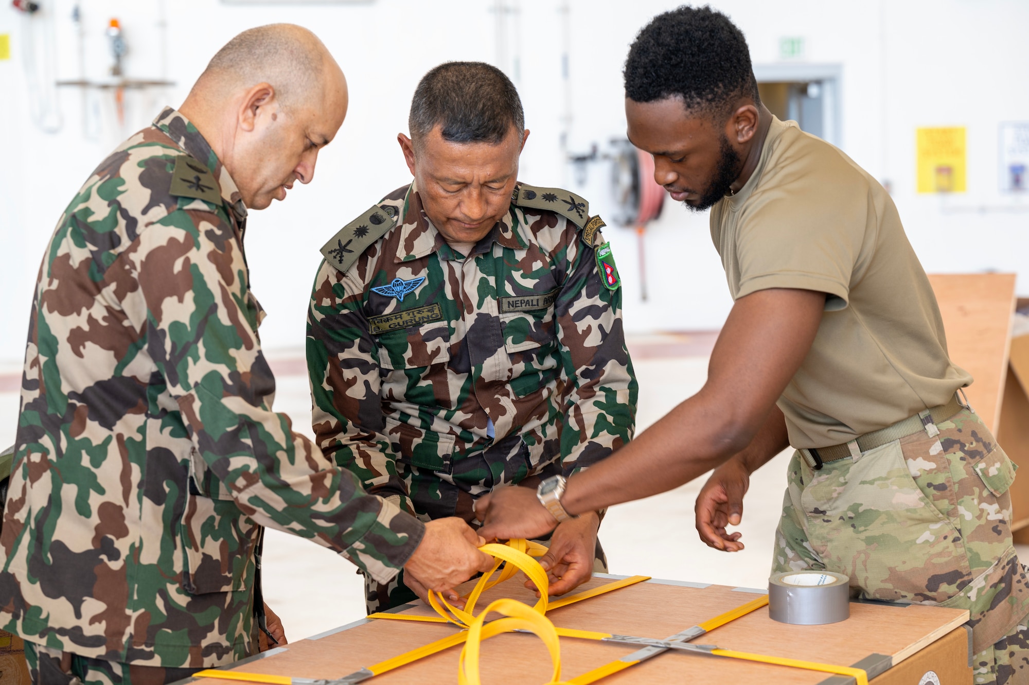 Photo of Operation Christmas Drop 2023 volunteers bundling airdrops.