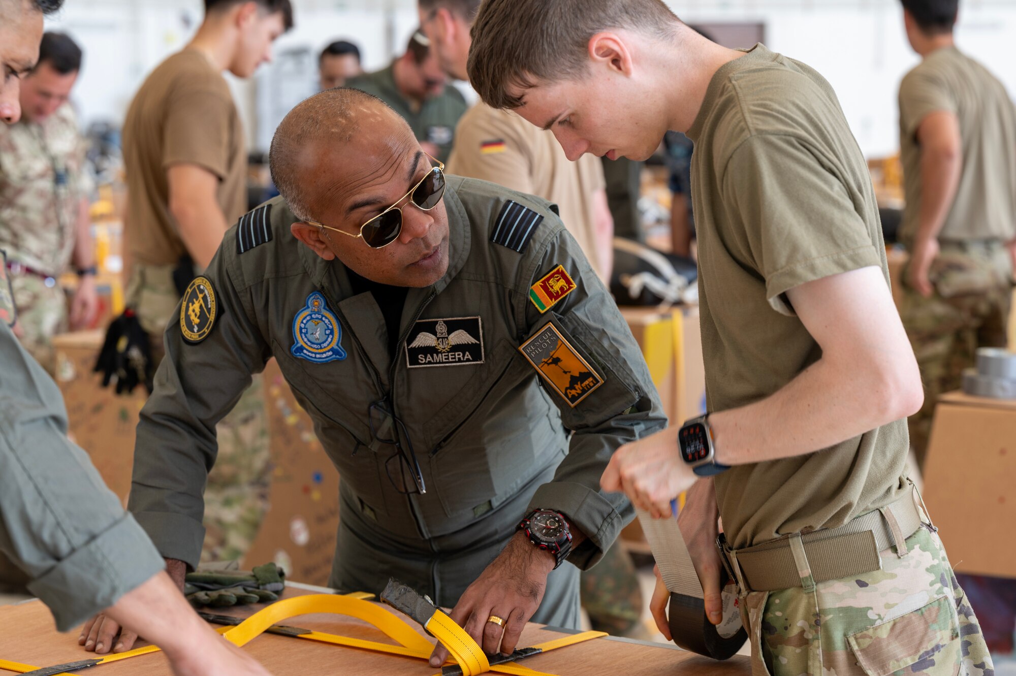 Photo of Sri Lanka Air Force leader speaking with U.S. Air Force Airmen.