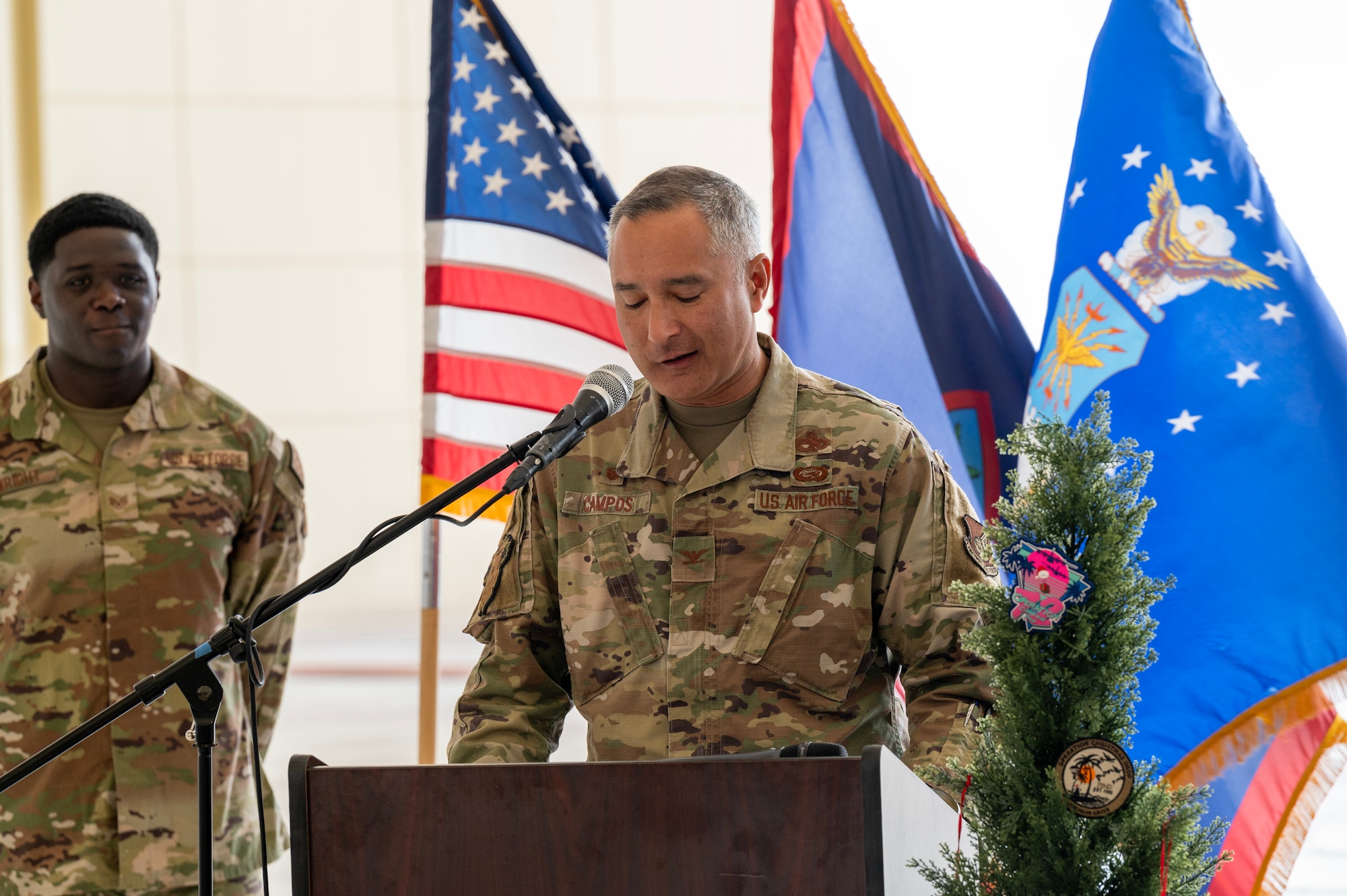 Photo of the 374th Mission Support Group commander speaking during a ceremony for Operation Christmas Drop