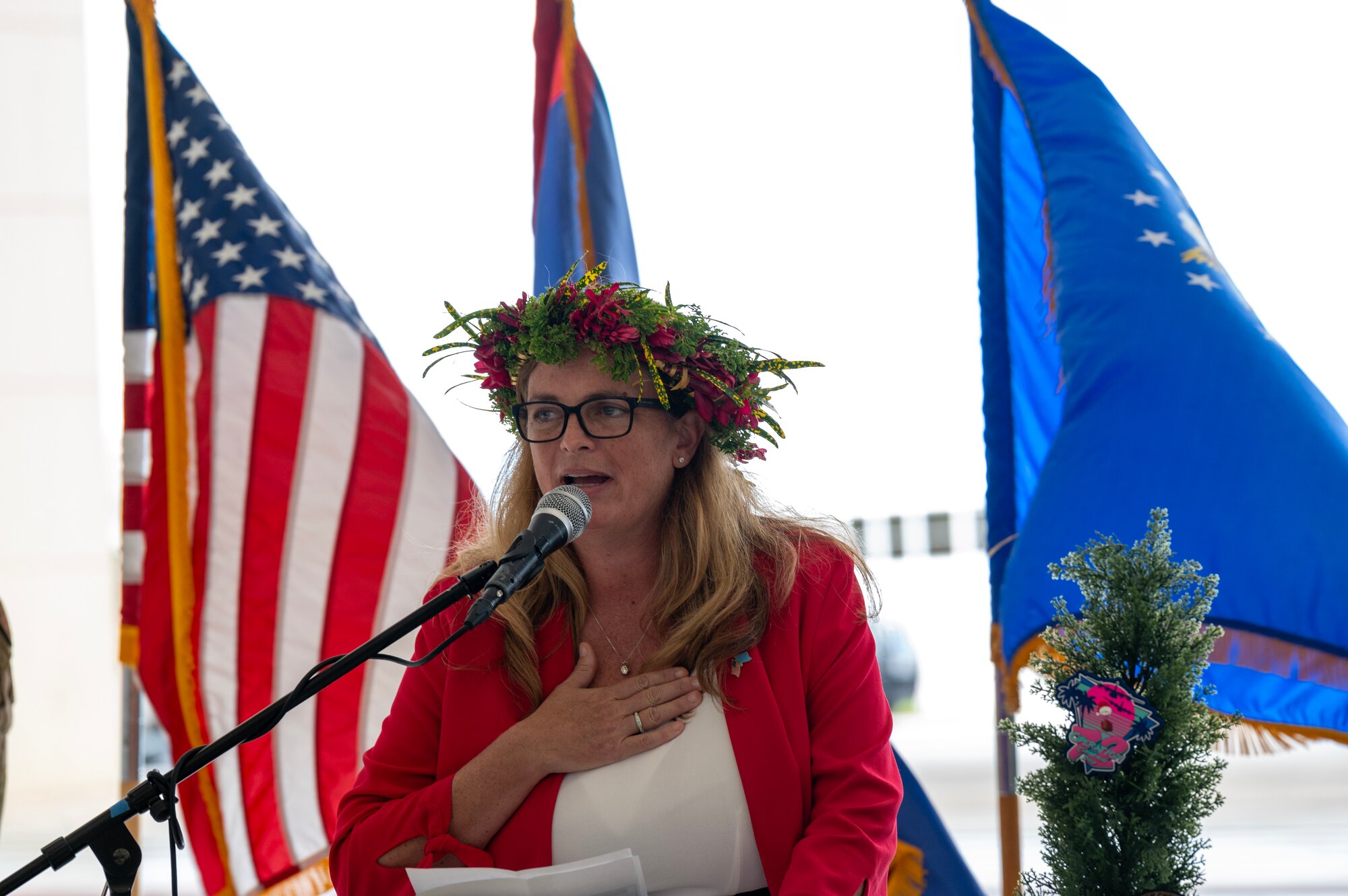 Photo of a U.S. Ambassador speaking during a ceremony for Operation Christmas Drop