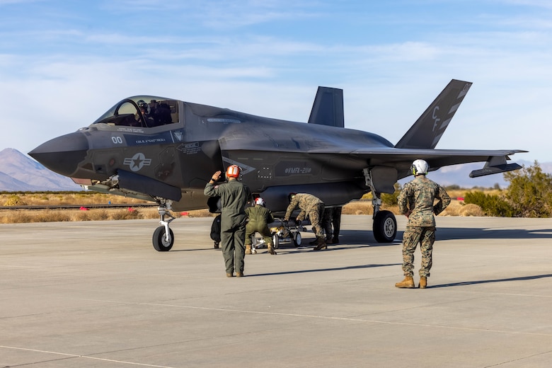 U.S. Marines with the 3rd Marine Aircraft Wing All Type Model Series Armament Team load ordnance onto an F-35B Lightning II aircraft at a forward arming and refueling point at in support of Exercise Steel Knight 23.2 at Inyokern Airfield, California, Dec. 2, 2023.  ATAT is comprised of aviation ordnance Marines qualified to load and arm every type model series platform in the 3rd MAW fleet. Steel Knight 23.2 is a three-phase exercise designed to train I Marine Expeditionary Force in the planning, deployment and command and control of a joint force against a peer or near-peer adversary combat force and enhance existing live-fire and maneuver capabilities of the Marine Air-Ground Task Force. (U.S. Marine Corps photo by Lance Cpl. Jennifer Sanchez)