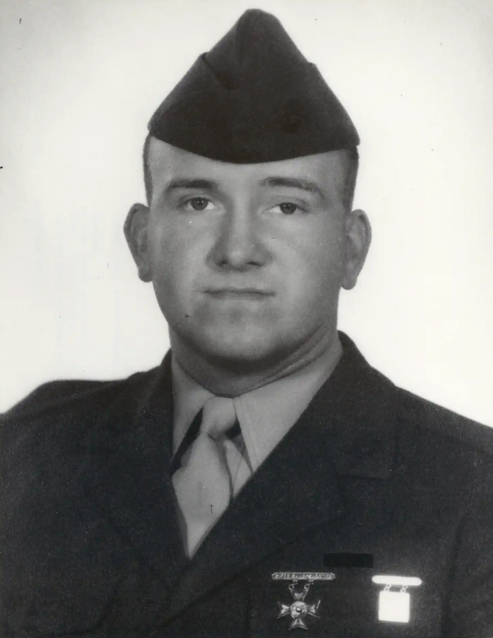 A man in uniform poses for a photo.
