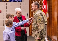 Col. Gregory Settle is “pinned” with his new rank by his mother, Beverly Hart and his sons, Jackson and Wesley at the Illinois Military Academy in Springfield, Illinois.