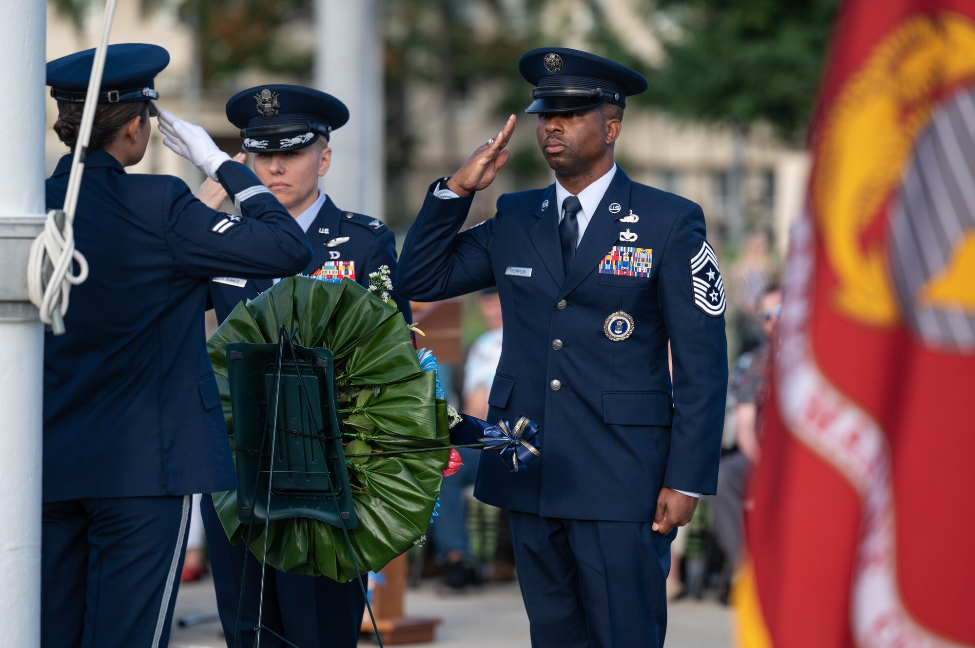 Col. Michele Lo Bianco, 15th Wing commander, and Chief Master Sgt. Anthony Thompson Jr., 15th Wing command chief, render a salute while dedicating a wreath during a December 7th Remembrance Ceremony at Joint Base Pearl Harbor-Hickam, Hawaii, Dec. 7, 2023. Multiple organizations donated a wreath in honor of those who lost their lives during the attacks on Pearl Harbor and Hickam Field. (U.S. Air Force photo by Staff Sgt. Alan Ricker)