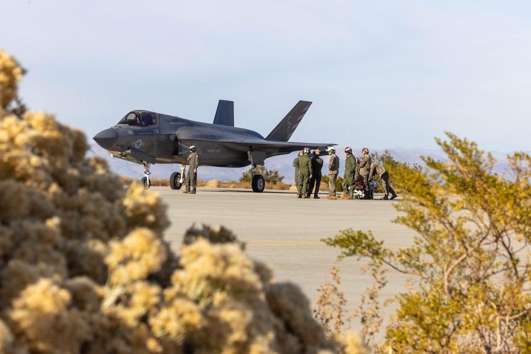 U.S. Marines with the 3rd Marine Aircraft Wing All Type Models Series Armament team prepare to load ordnance onto an F-35B Lightning II aircraft at a forward arming and refueling point in support of Exercise Steel Knight 23.2 at Inyokern Airfield, California, Dec. 2, 2023. ATAT is comprised of aviation ordnance Marines qualified to load and arm every type model series platform in the 3rd MAW fleet. Steel Knight 23.2 is a three-phase exercise designed to train I Marine Expeditionary Force in the planning, deployment and command and control of a joint force against a peer or near-peer adversary combat force and enhance existing live-fire and maneuver capabilities of the Marine Air-Ground Task Force. (U.S. Marine Corps photo by Lance Cpl. Jennifer Sanchez)