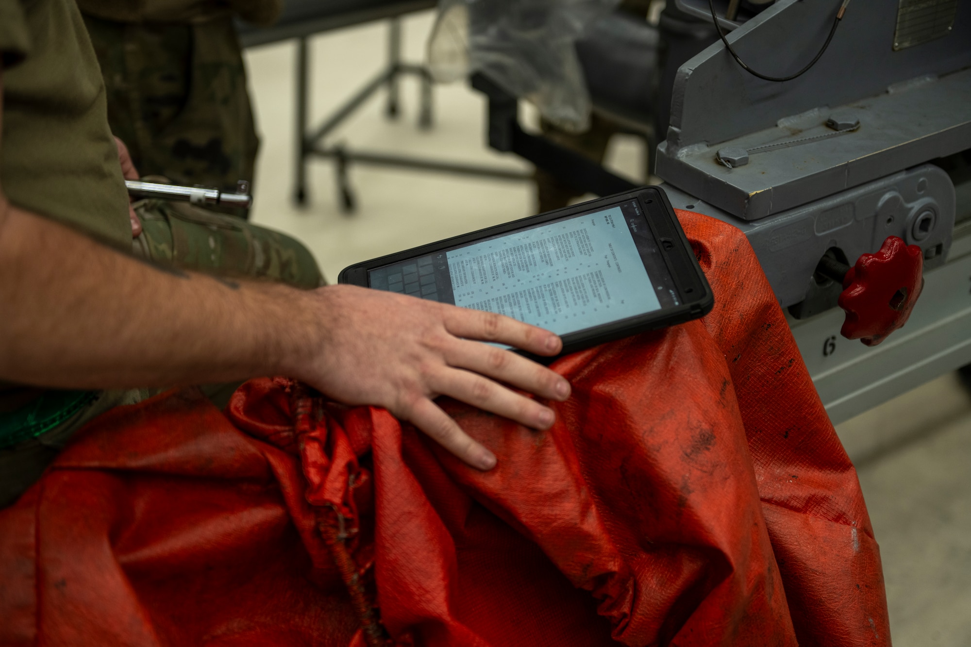 A photo of a person touching their hand to an iPad.