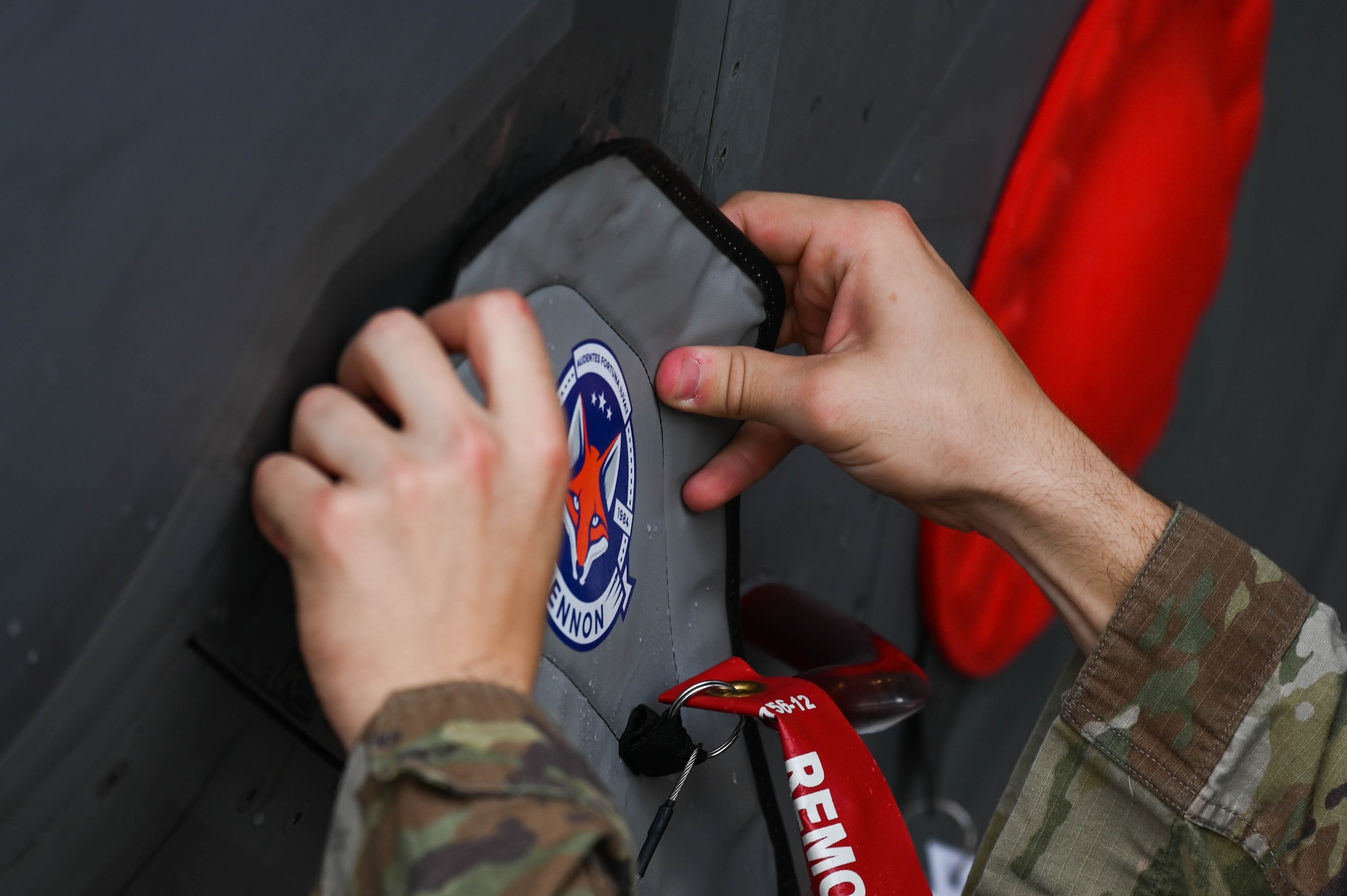 U.S. Air Force Tech. Sgt. Andrew McCamish, a 58th Aircraft Maintenance Unit aircraft section chief, and U.S. Air Force Staff Sgt. Tyler Schmitt, a 33rd Maintenance Group quality assurance inspector, developed reusable wash covers and a new canopy cover for the F-35A Lightning II at Eglin Air Force Base, Florida.