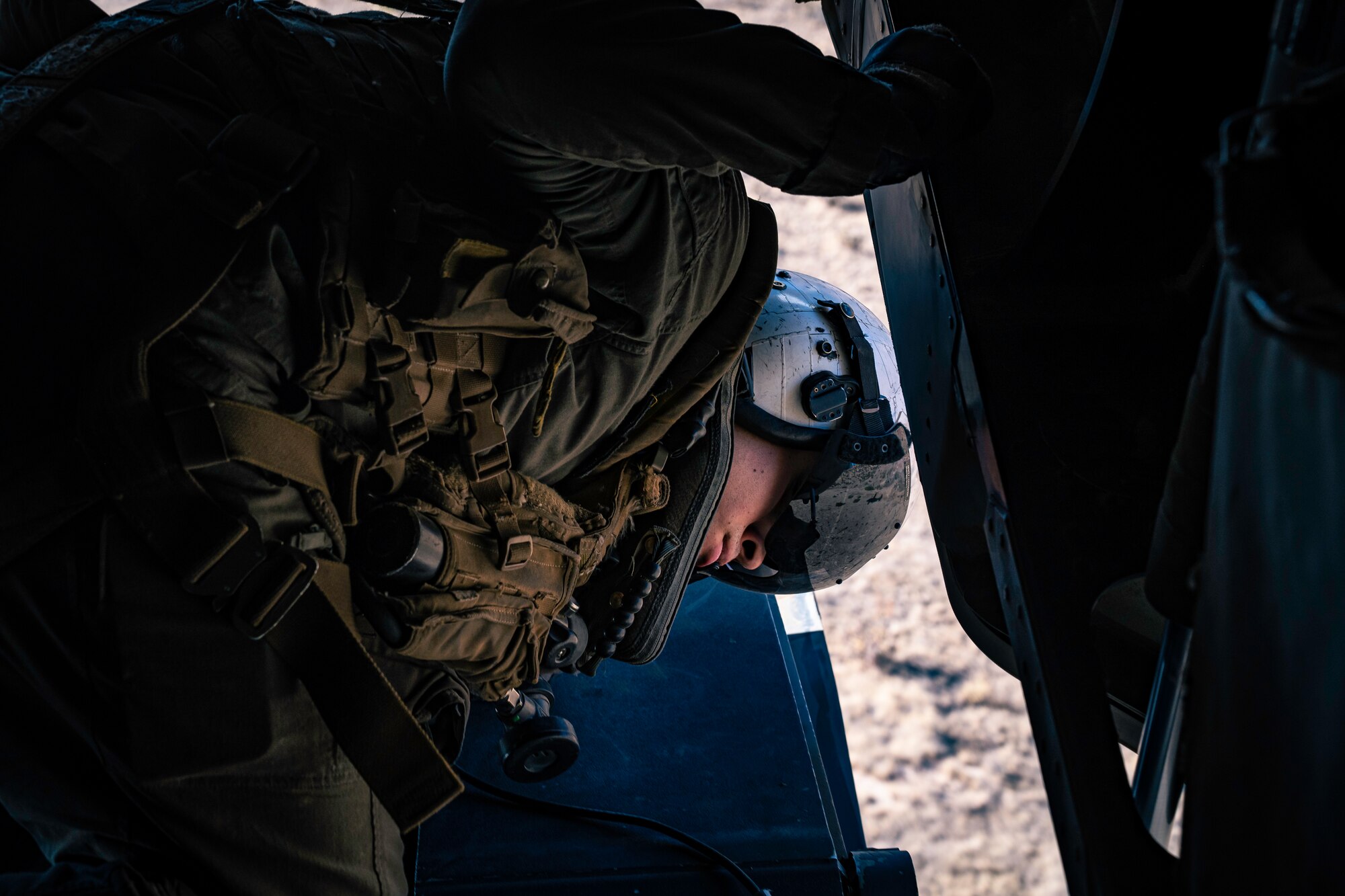 Man guides helicopter into land.
