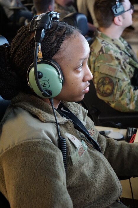 uniformed military pilot flys an MQ-9 simulator