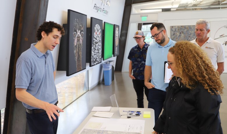 Brian McDowell, an environmental coordinator with the U.S. Army Corps of Engineers, left, discusses biodiversity restoration of the proposed Rio Salado Oeste Project with Maricopa County residents during a public meeting Nov. 18 in Phoenix.