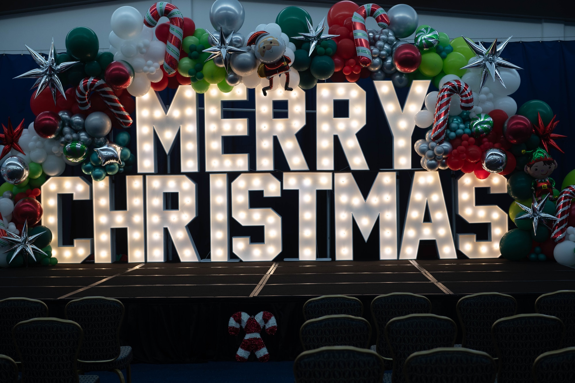 A merry Christmas sign in the Sunrise Conference Center lights up for the Tree Lighting Ceremony at Andersen Air Force Base, Guam, Dec. 1, 2023. The ceremony is an annual event for Team Andersen. (U.S. Air Force photo by Airman Lapaix)