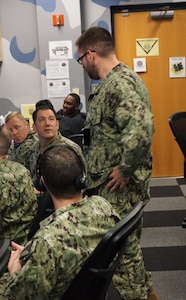 uniformed military members work on computers