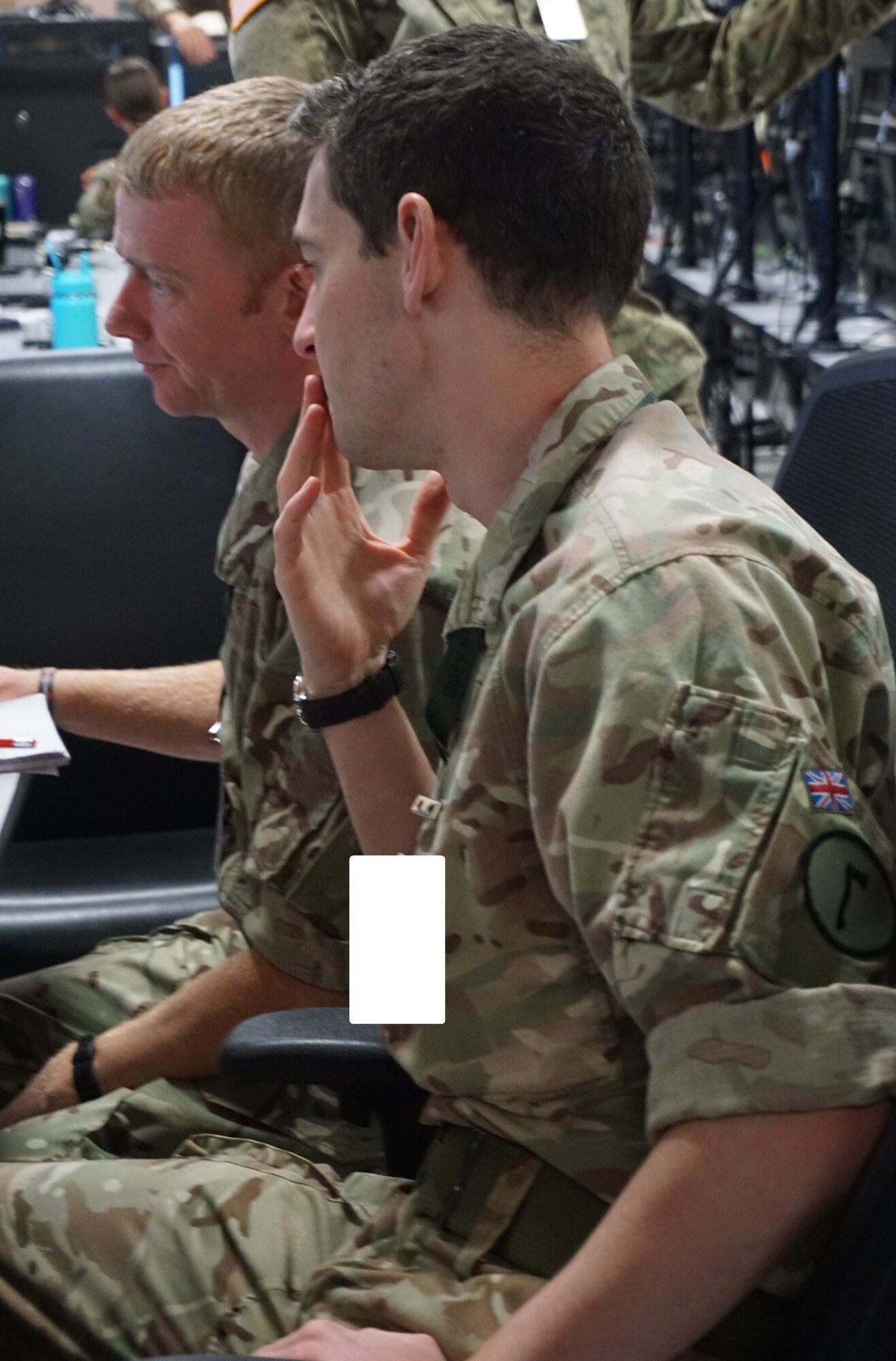 Alt text: uniformed military members work on computers