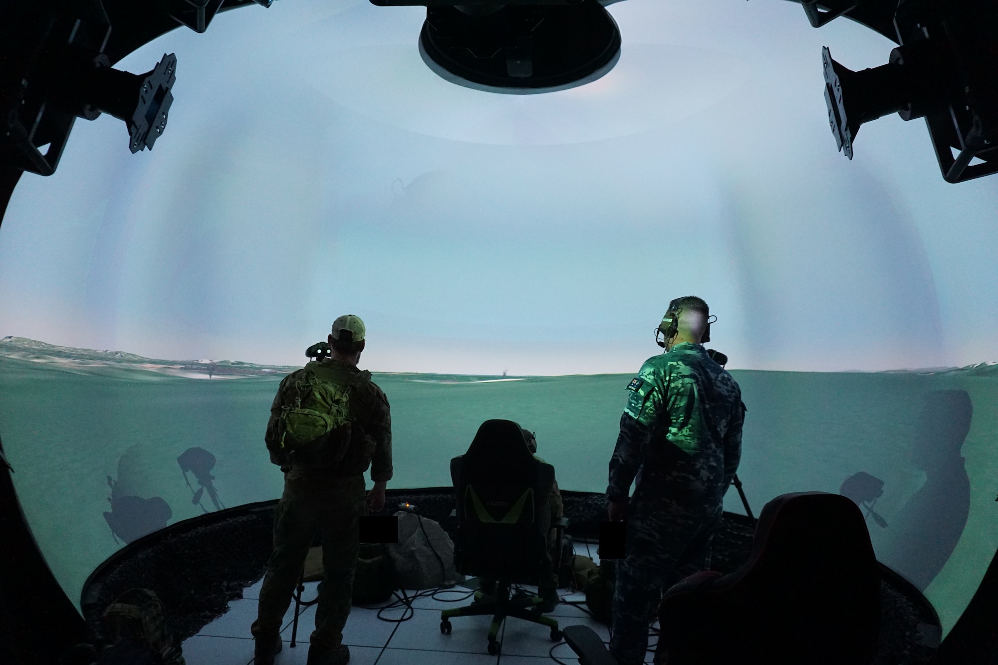 uniformed coalition forces work in a virtual simulated environment