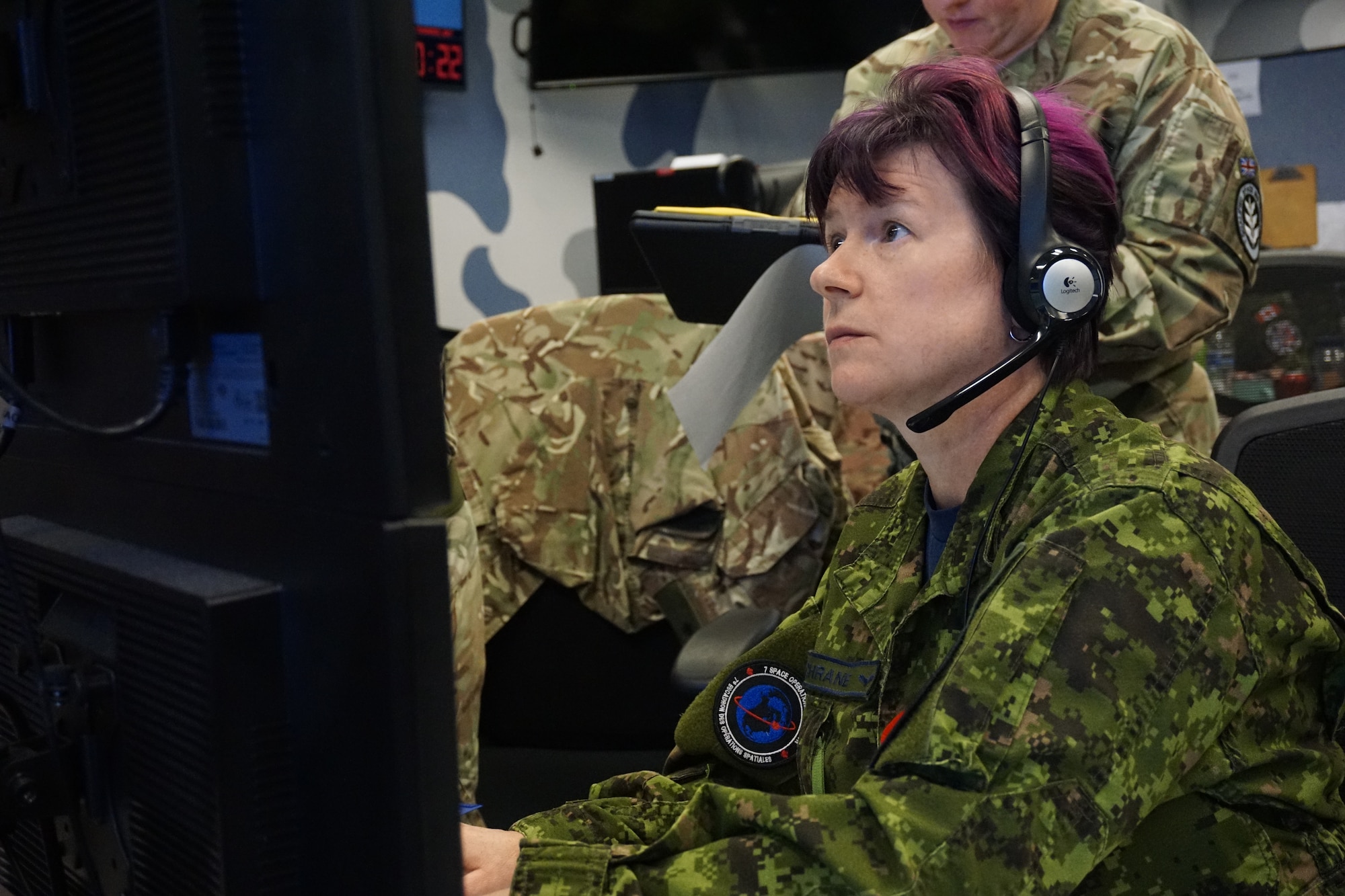 uniformed military members working  computers