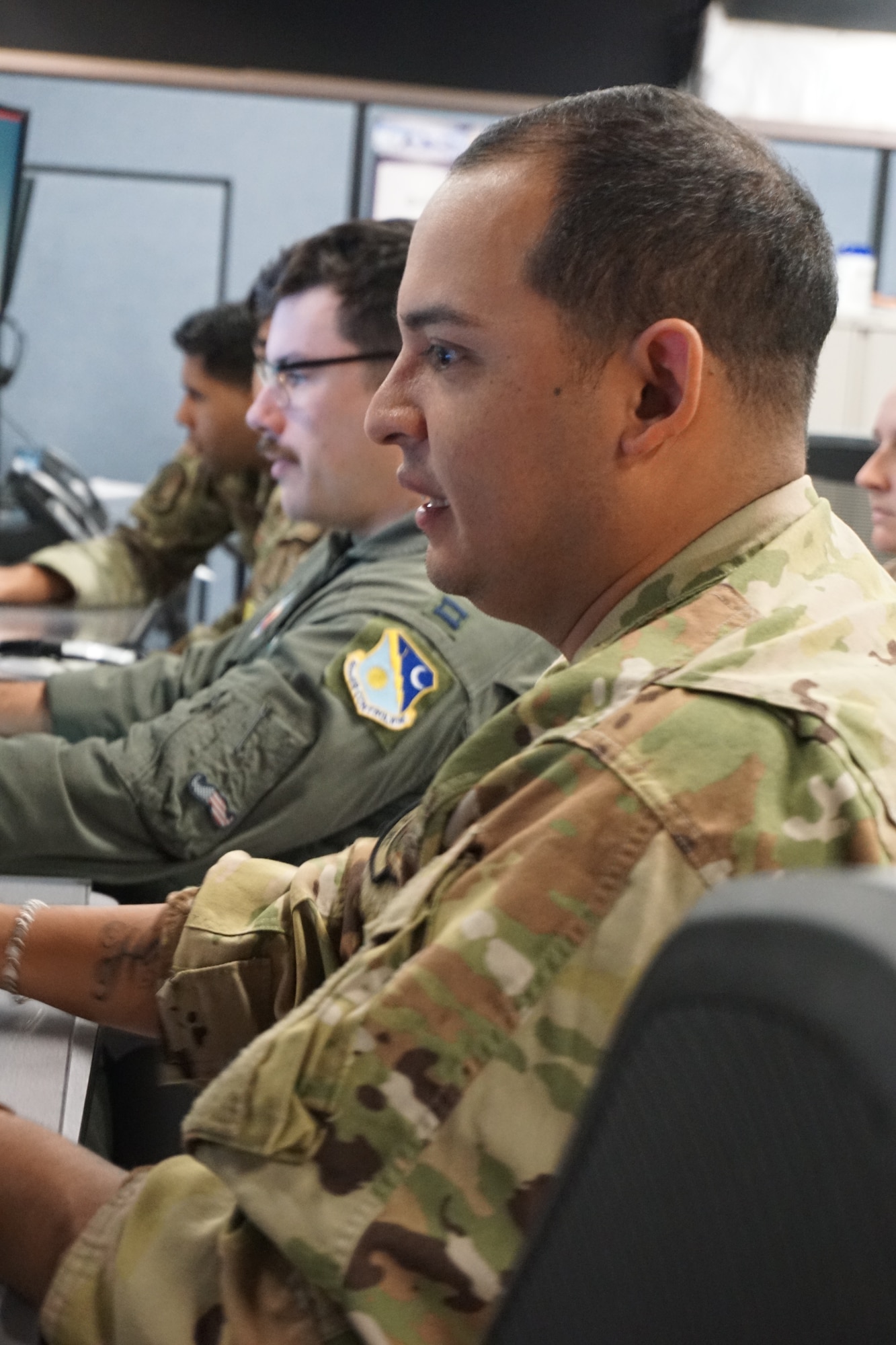uniformed military members working at computers