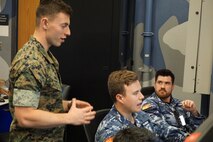 uniformed military members working at computers