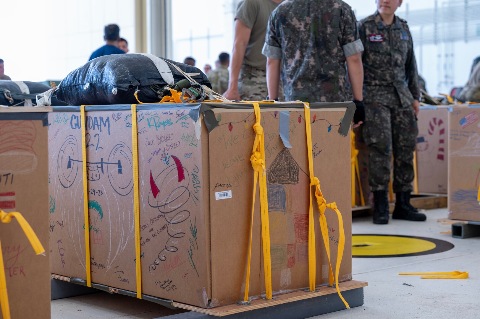 Photo of Operation Christmas Drop 2023 bundles awaiting to be loaded onto aircraft.