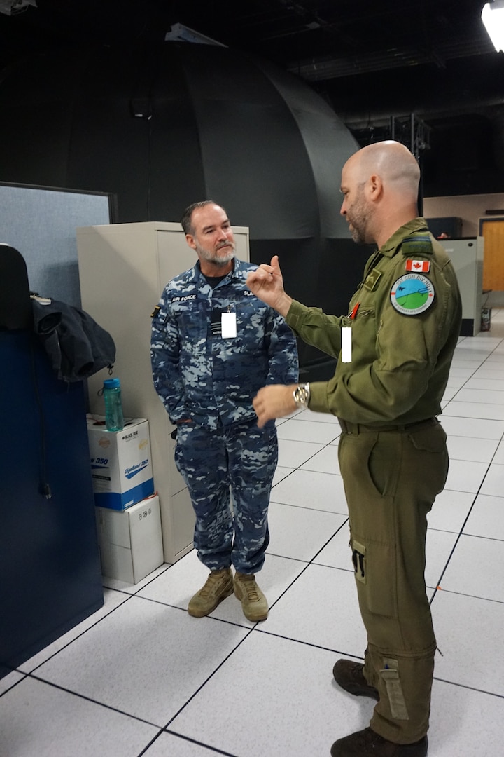 Alt text: two uniformed military members talking