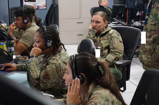  military members working at computers