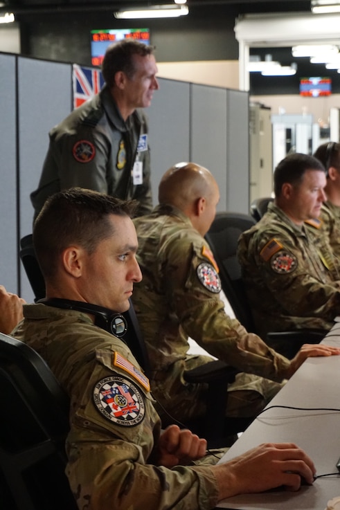  uniformed military members work at computers