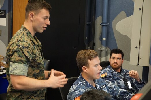  uniformed military members working at computers
