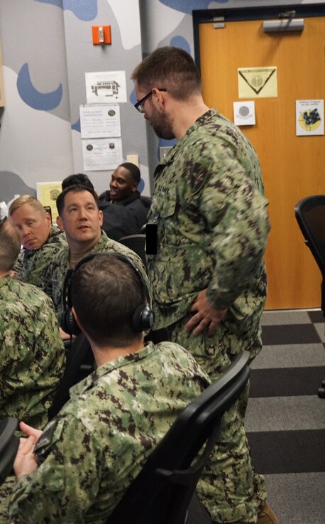  uniformed military members work on computers