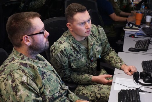  uniformed military members working at computers