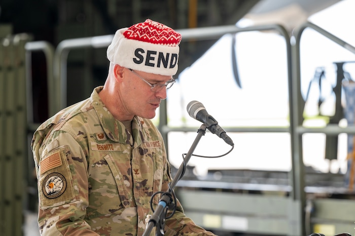Photo of a USAF leader speaking during a ceremony for Operation Christmas Drop