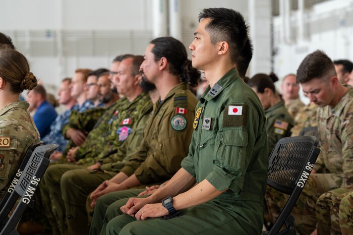 Photo of attendees at a ceremony listening to speakers