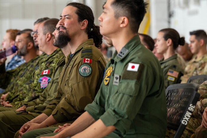 Photo of attendees at a ceremony listening to speakers