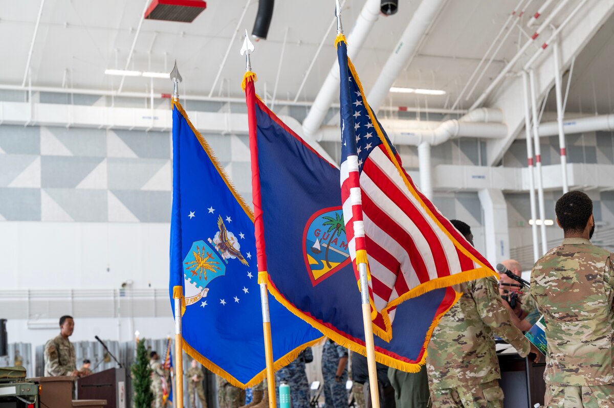 Photo of the U.S., Guam, and U.S. Air Force flags during the Operation Christmas Drop 2023 Push Ceremony