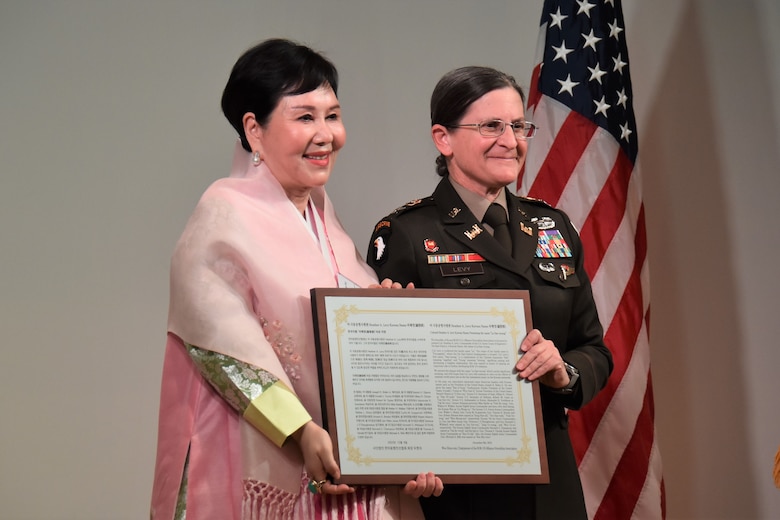 Ms. Woo, Hyun-euy, chairperson, Republic of Korea-U.S. Alliance Friendship Association, presents Col. Heather Levy, commander, U.S. Army Corps of Engineers - Far East District, with a plaque of an honorary Korean name.
