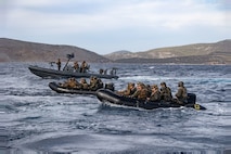 U.S. Marines from the 26th Marine Expeditionary Unit (Special Operations Capable) execute a small-scale amphibious assault alongside Greek Marines with 32nd Hellenic Marine Brigade during a bilateral exercise near Skyros, Greece, Dec. 2, 2023. U.S. Marines and Sailors of the 26th Marine Expeditionary Unit (Special Operations Capable), embarked on the ships of the Bataan Amphibious Ready Group, are on a scheduled deployment as the Tri-Geographic Combatant Command crisis response force with elements deployed to the U.S. 5th Fleet and U.S. 6th Fleet areas of operation to increase maritime security and stability, and to defend U.S., Allied, and Partner interests. (U.S. Marine Corps photo by Cpl. Michele Clarke)