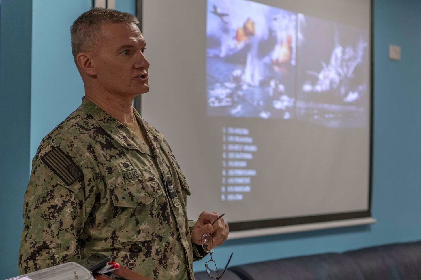Capt. Odin J. Klug, commanding officer, Naval Support Activity  Souda Bay, talks about the heroic actions taken by Sailors during the 1941 attack on Pearl Harbor during a Pearl Harbor Remembrance Day Ceremony in The Anchor on Dec. 7, 2023.
