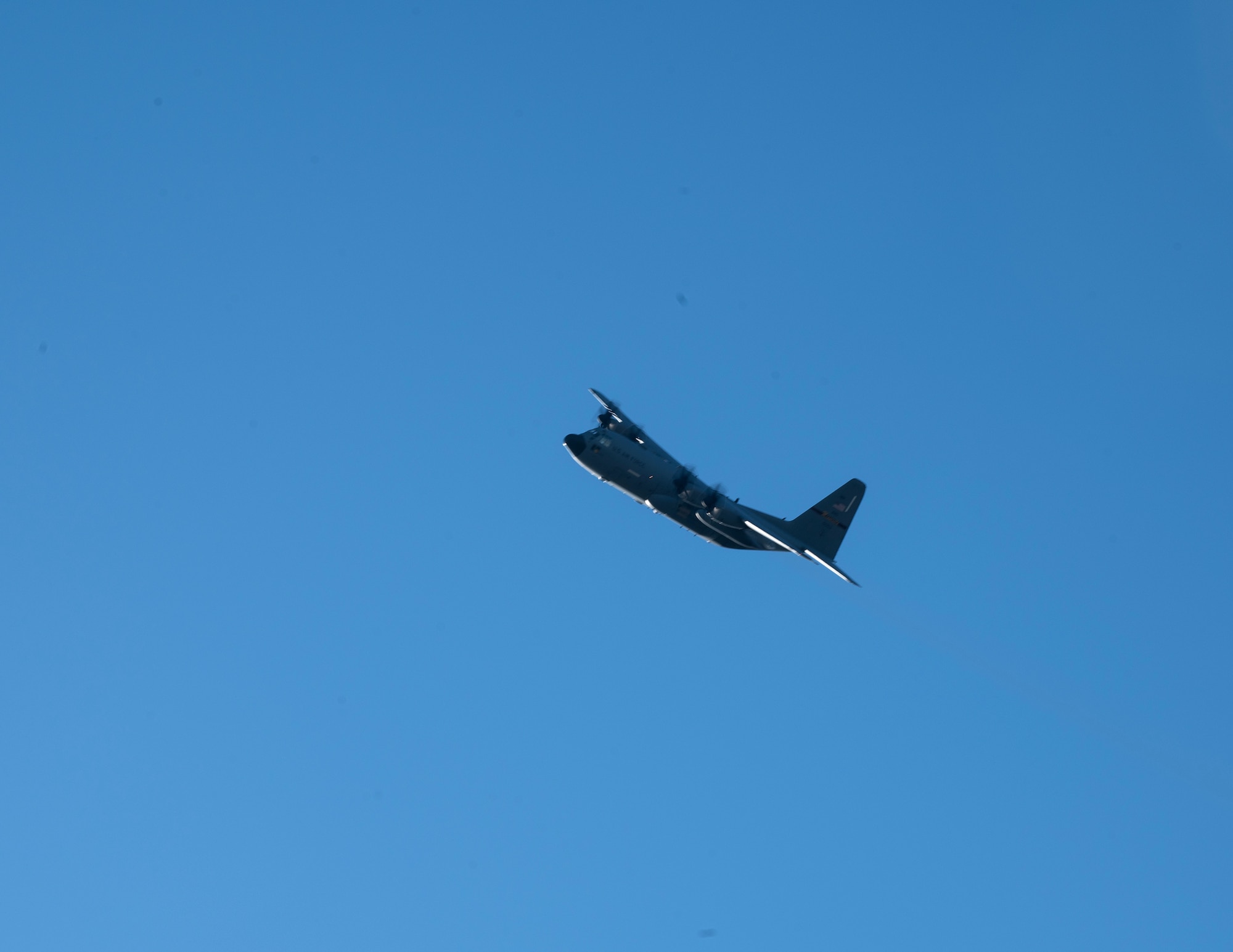 A C-130 Hercules from the 133rd Airlift Wing flies over waiting families and friends in St. Paul, Minn., Dec. 7, 2023.