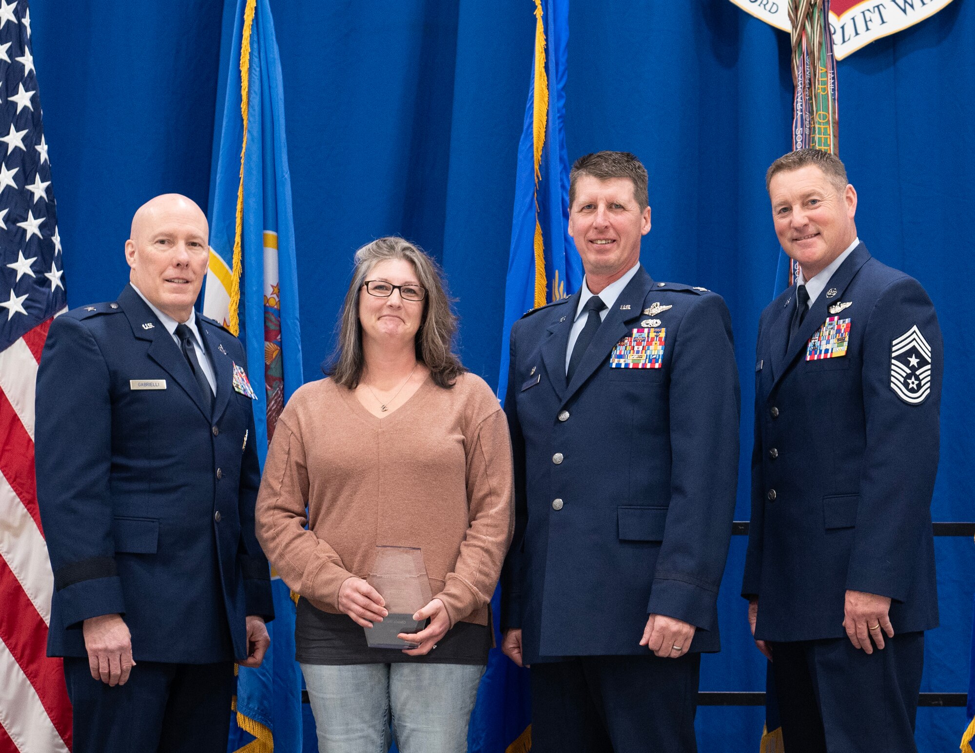 Glenda Huber, wife to U.S. Air Force Senior Master Sgt. Nick Huber, 133rd Logistics Readiness Squadron, receives the 2023 Key Volunteer Award in St. Paul, Minn., Dec. 3, 2023.