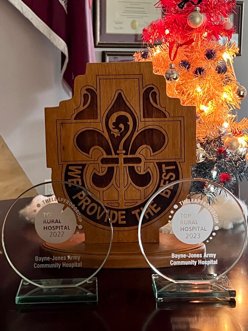 Group of three trophies arranged on a table top.