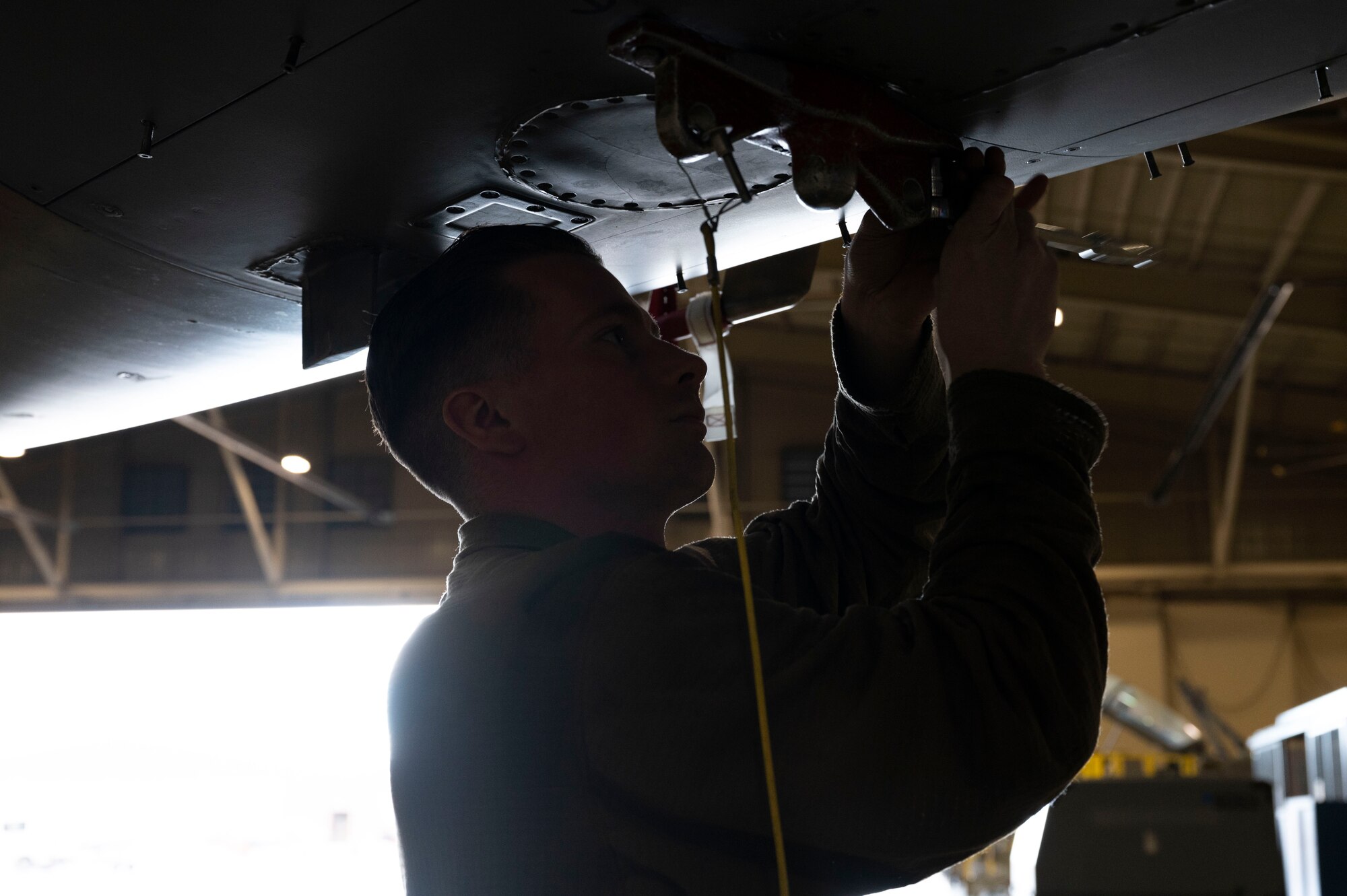 U.S. Air Force Staff Sgt. Elliott Tuepker, 49th Equipment Maintenance Squadron aircraft inspection section journeyman, prepares to lift an F-16 Viper for an inspection at Holloman Air Force Base, New Mexico, Dec. 1, 2023. Phase inspections are performed with high attention to detail to ensure all F-16s are ready for operational use. (U.S. Air Force photo by Airman 1st Class Isaiah Pedrazzini)