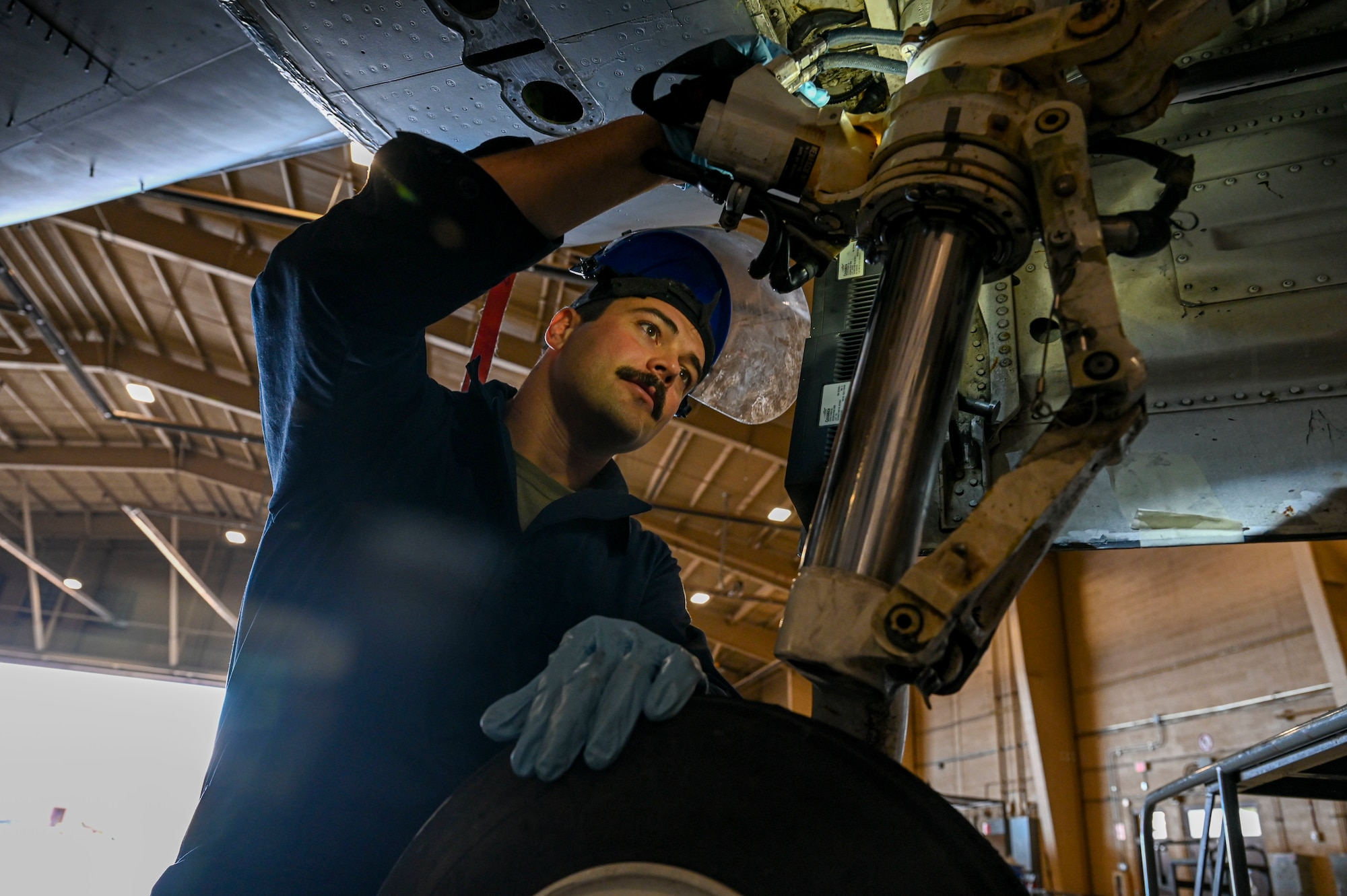 U.S. Air Force Airman 1st Class Ian Byorth, 49th Equipment Maintenance Squadron aircraft inspection section journeyman, prepares to apply lubricant to the landing gear of an F-16 Viper at Holloman Air Force Base, New Mexico, Dec. 1, 2023. The 49th EMS phase sections work hand-in-hand with  the other aircraft maintenance units across base to ensure that Holloman’s pilots continue to conduct safe flight operations. (U.S. Air Force photo by Airman 1st Class Isaiah Pedrazzini)