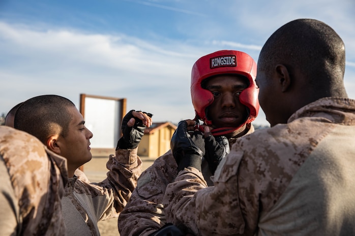 A U.S. Marine Corps recruit with Bravo Company, 1st Recruit Training Battalion, prepares for a body sparring event at Marine Corps Recruit Depot San Diego, Dec. 4, 2023. Body sparring teaches recruits self-defense and instills a combat warrior mindset. (U.S. Marine Corps photo by Lance Cpl. Sarah M. Grawcock)