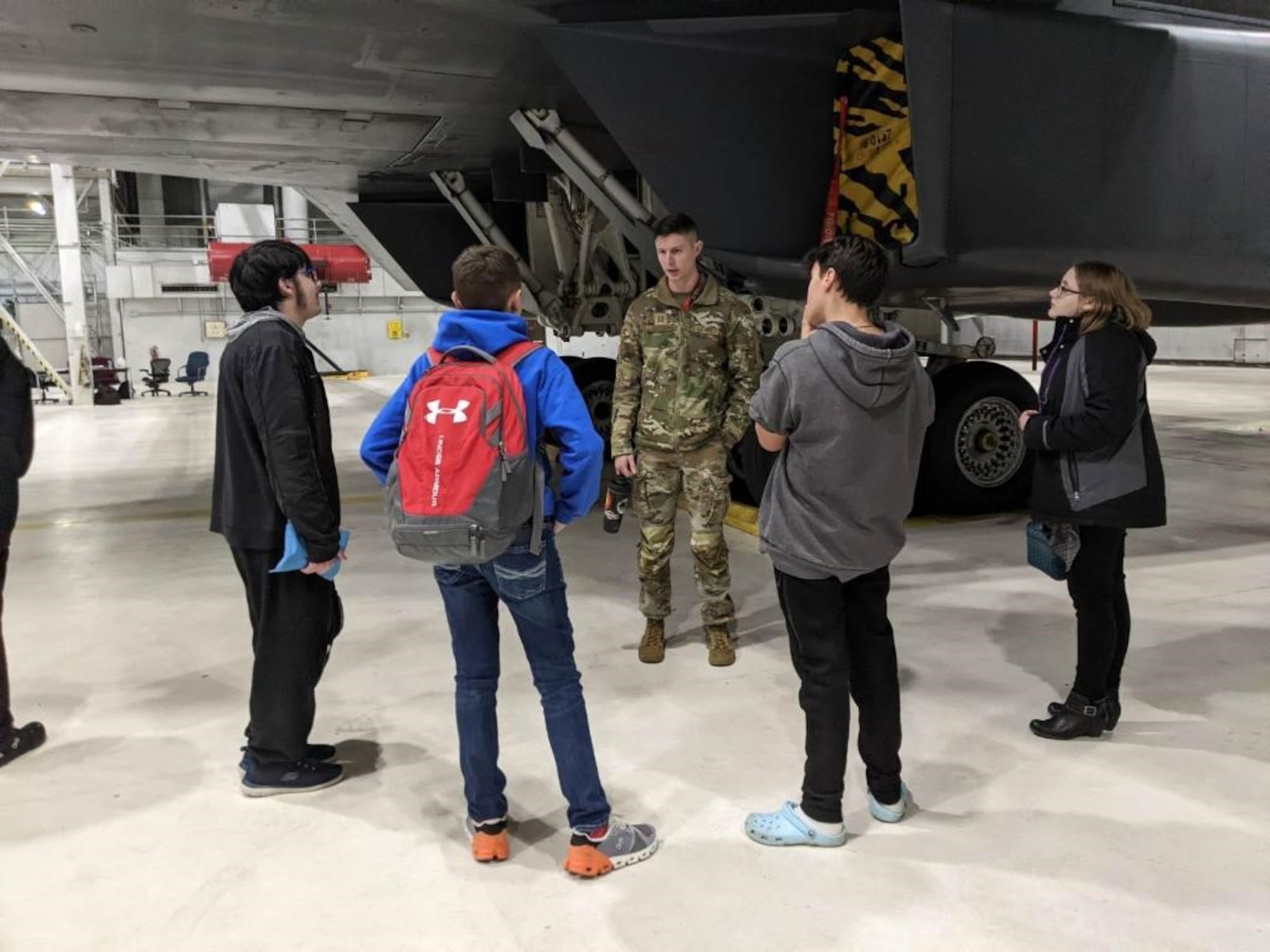 Capt. John Jordan, 34th Aircraft Maintenance Unit officer in charge, discusses the B-1B Lancer with students from a local middle school as part of a base tour at Ellsworth Air Force Base, South Dakota, Dec. 5, 2023.