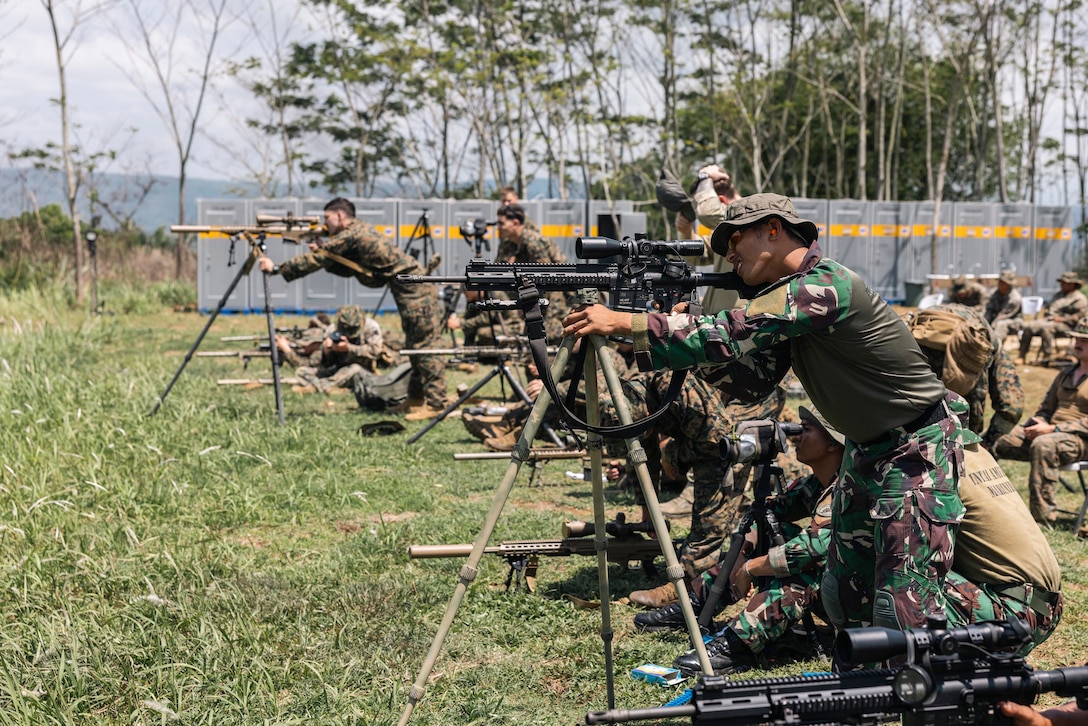 U.S. and Indonesian service members practice marksmanship during daylight.