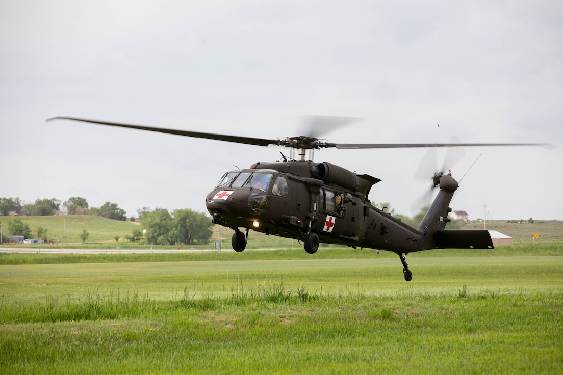 A HH-60M Blackhawk lands in the grass during their annual wildland fire recertification training near Hot Springs, S.D., May 26, 2023. Soldiers with the 1/189th Aviation Reg., Charlie Co. worked closely with the South Dakota Wildland Fire Division and local dispatch to recertify and stay ready to serve the community and state in the event of a wildland fire and practiced bucket drops they pulled from Angostura Reservoir. (U.S. Army National Guard photo by Staff Sgt. Breanne Donnell)