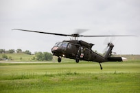 A UH-60 Blackhawk lands in the grass during their annual wildland fire recertification training near Hot Springs, S.D., May 26, 2023. Soldiers with the 1/189th Aviation Reg., Charlie Co. worked closely with the South Dakota Wildland Fire Division and local dispatch to recertify and stay ready to serve the community and state in the event of a wildland fire and practiced bucket drops they pulled from Angostura Reservoir. (U.S. Army National Guard photo by Staff Sgt. Breanne Donnell)