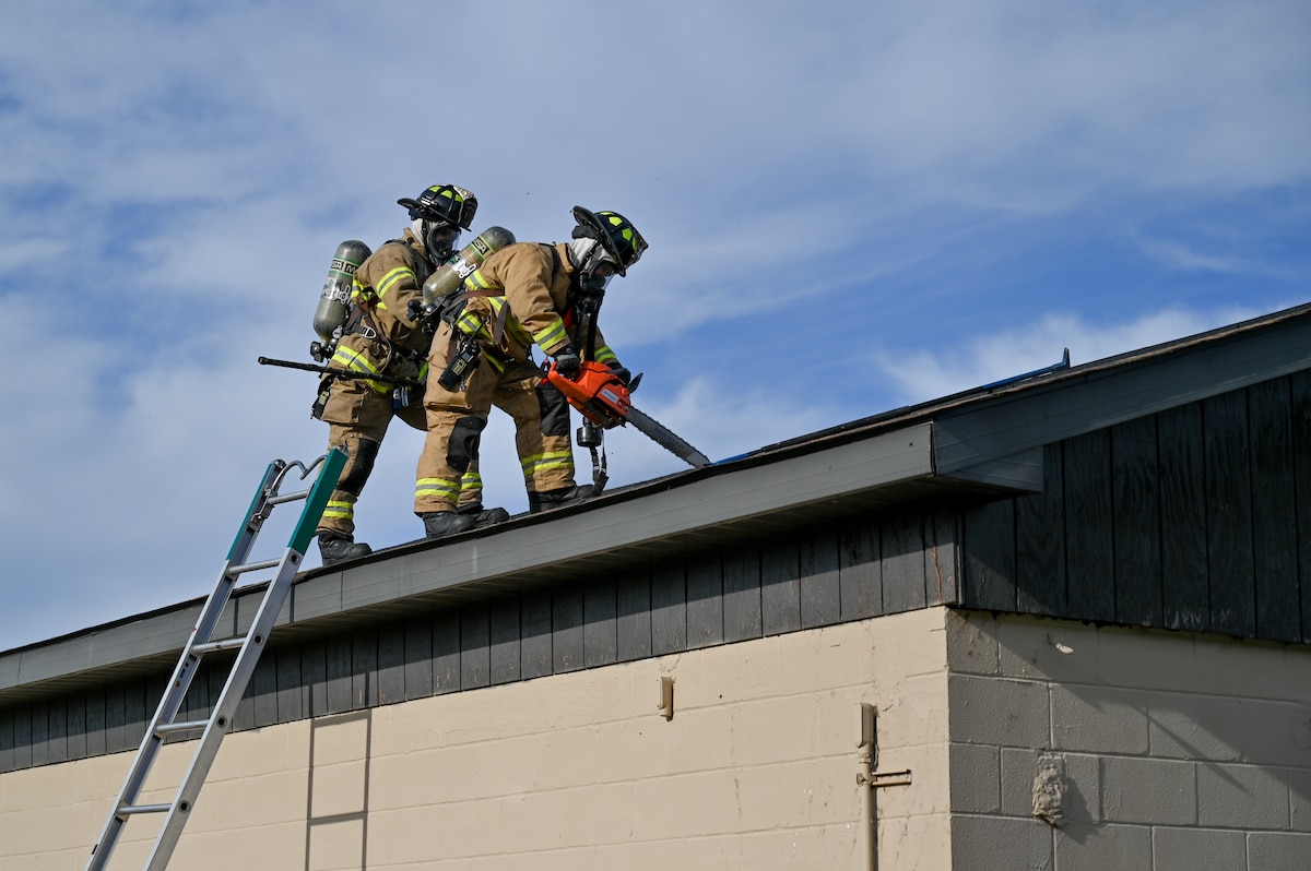 Airmen assigned to the 175th Wing Fire Department saw into the roof of a simulated burning building to inspect for fire hazards during Operation Frosty Strike Nov. 30, 2023, at Martin State Air National Guard Base, Middle River, Md. Operation Frosty Strike was a full-scale readiness exercise that demonstrated the 175th Wing’s ability to survive and operate in a realistic combat environment against a near-peer adversary while fulfilling its federally assigned missions.